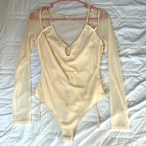 Mesh long-sleeve bodysuit with halter tie & keyhole opening.